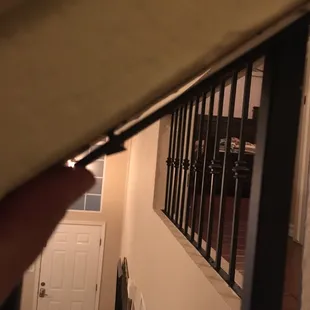 a hand holding a railing