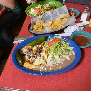 Ummm forgot food name but it is pollo (chicken) and chorizo (Mexican susage) on top w/ rice and beans