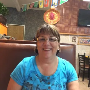 a woman sitting at a table in a restaurant