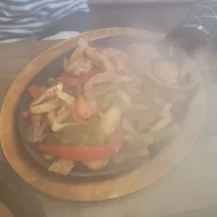 Fajitas Vallarta (shrimp, chicken, and beef) -- brought out on a sizzling platter!