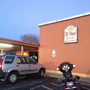a motorcycle parked in front of a restaurant