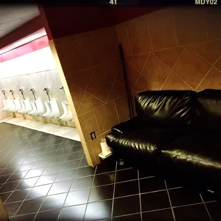 Ultra low urinals with no dividers for privacy and a couch available for casual viewing. The way men's rooms were meant to be