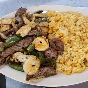 Fajita Mix with rice.  Beef/Chicken/Shrimp with grilled green bell pepper and onions.