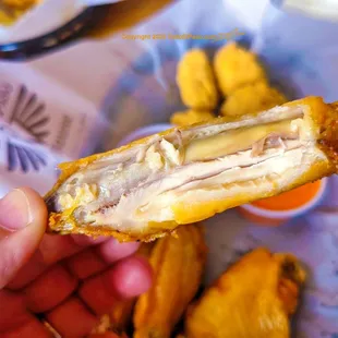 a hand holding a chicken wing