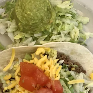 Beef taco with flour tortilla and guacamole salad