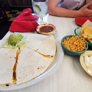 Chicken quesadilla, side of rice, and chips and salsa. The small-size margarita in the background.