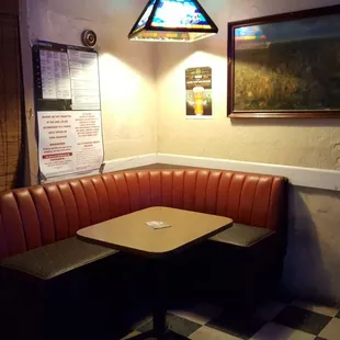 a corner booth with a checkered floor
