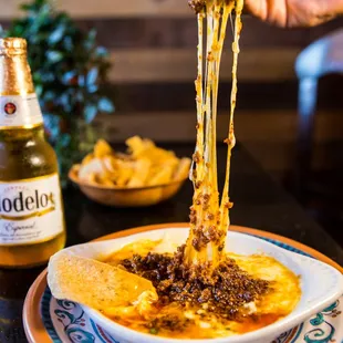 Let your tastebuds melt away with our delicious Queso Fundido topped with Chorizo