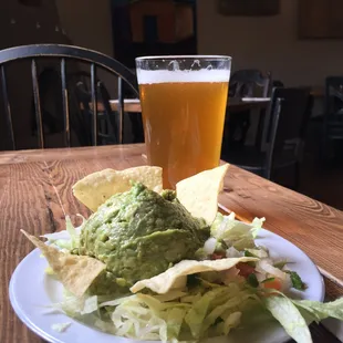 a plate of food and a glass of beer