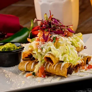 Taquitos, 5 Taquitos with Chicken or beef with sour cream, lettuce, tomato, and guacamole.