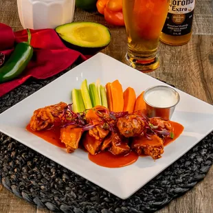 Crispy Chicken Wings, Bone in crispy wings flavored with your choice of sauce served with carrots and celery