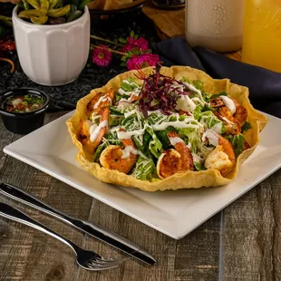 Tostada Salad Romaine lettuce, chicken or steak, rice, beans, pico de gallo, guacamole, corn, sour cream, and cheese, shrimp or Mahi Mahi.