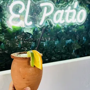a hand holding a coconut drink