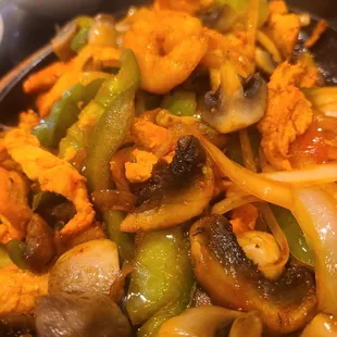 Shrimp and chicken fajitas with added grilled mushrooms.
