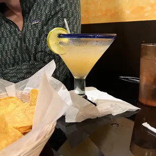 a man with a drink and chips