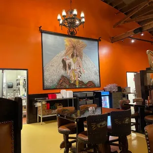 a dining room with orange walls