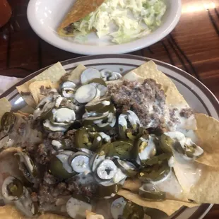 Beer nachos with queso and a beef taco