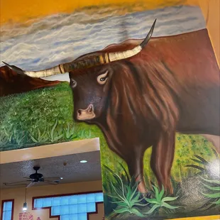 a painting of a bull with long horns