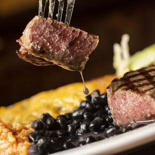 a piece of steak being lifted by a fork
