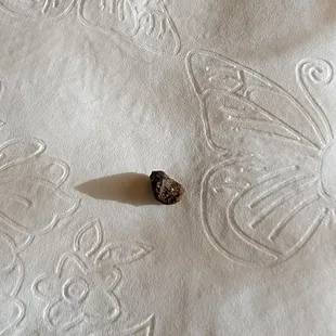 a small black object on a white tablecloth