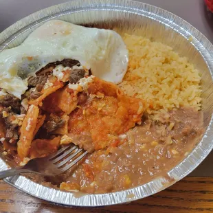 Chilequiles with asada added. Asada lacked a bit of flavor, but added more salsa. Pretty spicy too but good