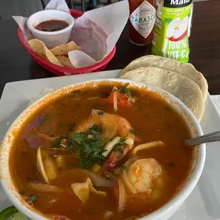 Seafood (spicy) soup. Very nice broth with mixed seafood. Yum. With rice side, tortillas, lime, jalapeños.