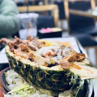 Chicken, cheese, and peppers in a pineapple