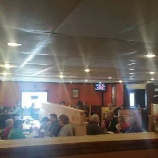 people sitting at tables in a restaurant