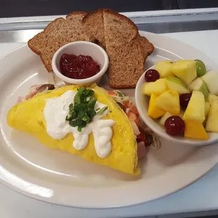 Omelette with a  side of fruits or rosemary potatoes.