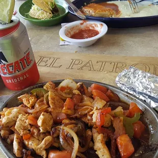 a plate of food and a can of beer