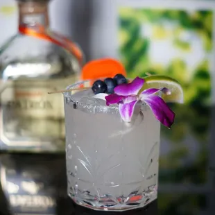 a drink with a flower garnish
