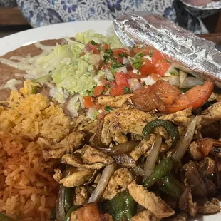Chicken fajita, rice and refried beans.