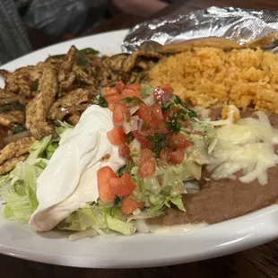 Chicken fajita, rice, and refried beans.