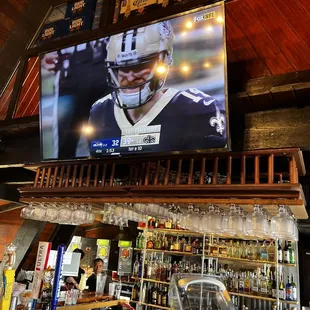 My seat at the bar catching the Saints game.