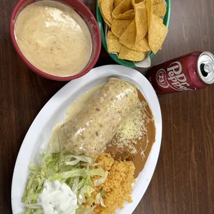 Bean dip with chip, pork chimichanga, and canned soda. (They serves jarrito's)