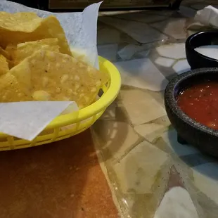 a bowl of chips and a bowl of salsa