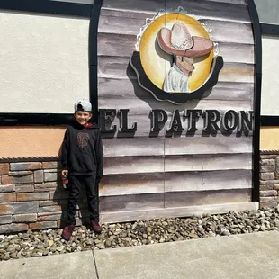 a man standing in front of a sign