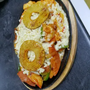 a pizza with pineapples and peppers