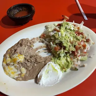 Beans, lettuce, guac, sour cream, and pico to go with fajitas