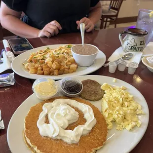 Grandson's pancake, egg and sausage In back is plate of migas