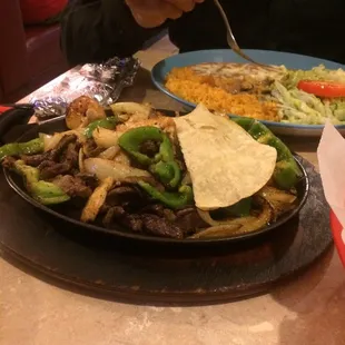 a plate of mexican food and a bowl of rice