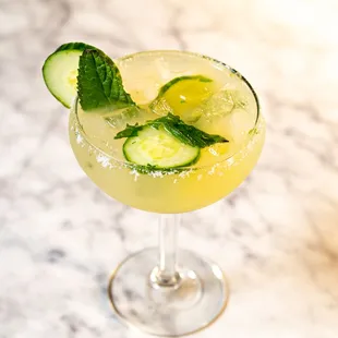a cocktail with cucumber and mint