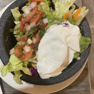 a bowl of salad with sour cream
