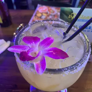 a margarita with a purple flower