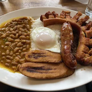 Bandeja Penol (Penol Plate) - Grilled steak, pork belly rind, fried egg, rice, beans, sweet plantains, and corn cake with Colombian sausage