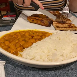 a plate of rice, beans and bread