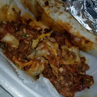 This is hers, al pastor and beans and onions and cheese and green salsa.