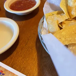 a bowl of chips and a bowl of salsa