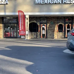 a car parked in front of a restaurant