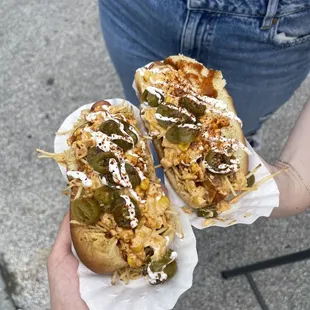 two hot dogs with toppings